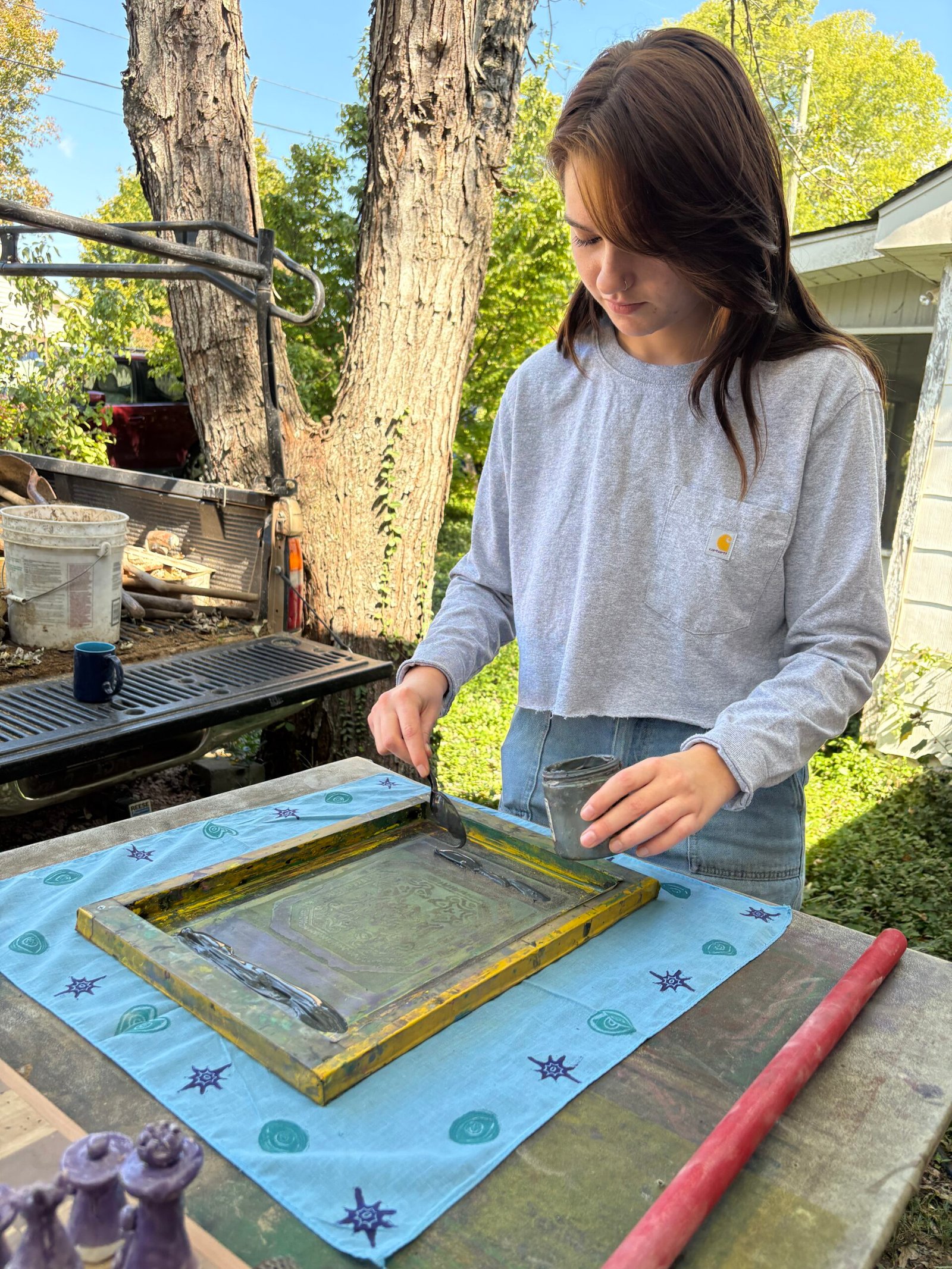 Hannah demonstrating silk printing at Stink Bug Studio in Knoxville, TN